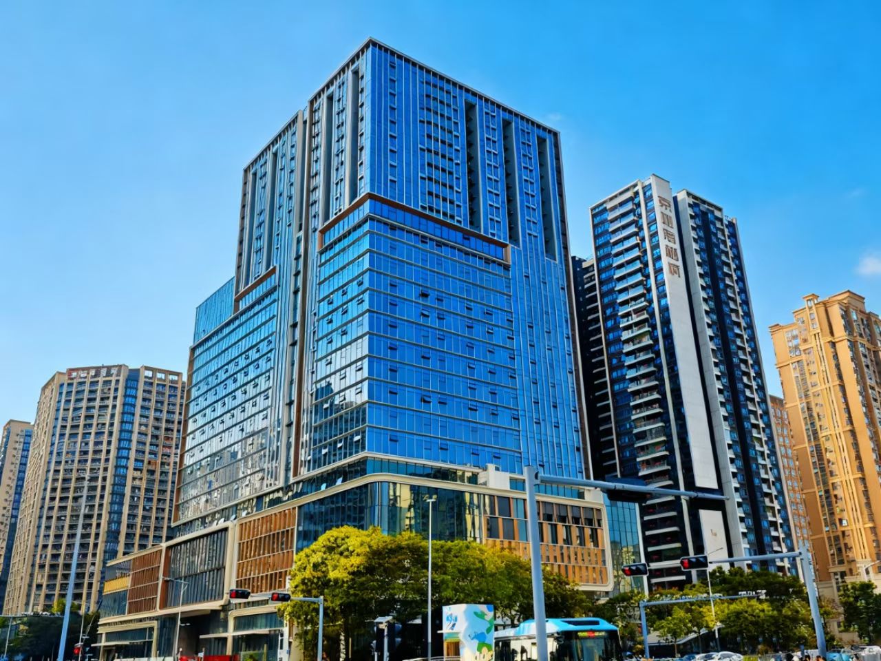 Professional corporate office building exterior with modern architecture, green landscaping, bright daylight